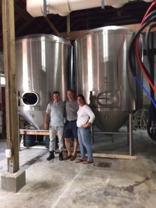 The Brewers and Susan in Front of tTheir Brand-New Fermenters
